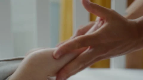 Close-up loving mother holds tiny feet of her newborn baby Stock Footage 305991490