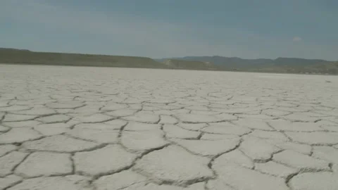 Close up low angle of the amazing salt pans of Lake nearby the silhouettes of Stock Footage 156465503