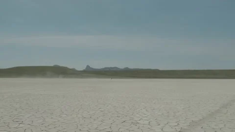 Close up low angle of the amazing salt pans of Lake nearby the silhouettes of Video stock 157012136