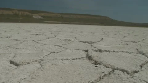 Close up low angle of the amazing salt pans of Lake nearby the silhouettes of Stock Footage 158950697