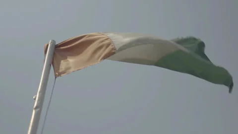 Close-up low angle Ivorian flag waving in wind, Ivory Coast Stockbeeldmateriaal 333561454