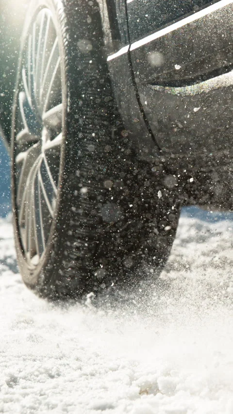 CLOSE UP Low angle shot of vehicle having problems driving along the snowy trail Stock Footage 315386571