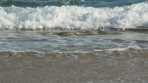 Close up low angle shot of waves breaking on sandy beach on sunny day in summer Stock Footage 108512629