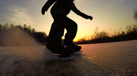 CLOSE UP, LOW ANGLE: Unrecognizable joyful man spraying ice when hockey stopping Stock Footage 68592881