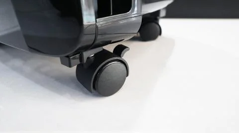 Close-up low angle view of an air cooler caster wheel with a locking brake .. Stock Photos