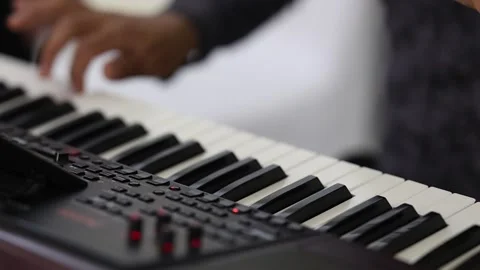 Close low-angle view of both hands playing electronic keyboard, fingers pressing Stock Footage 346083459