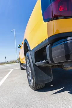 Close-up low angle view of the rear side of a bright yellow car Foto stock
