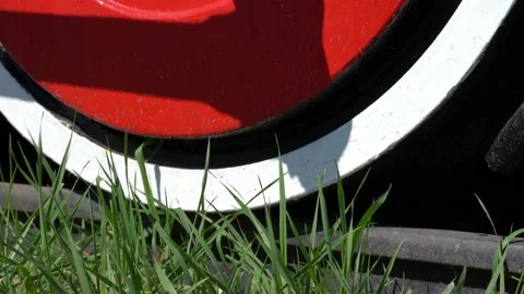 Close-up, low angle view of standard gauge steam locomotive driving wheel Stock Footage 183052401