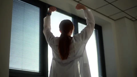 Close-up low-angle view of unrecognizable female doctor wearing white coat Stock Footage 152996080