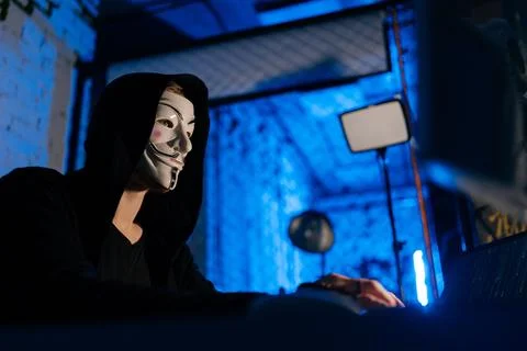 Close-up low-angle view of unrecognizable hooded hacker man wearing anonymous Stock Photos