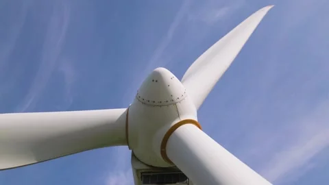 Close-up Low Angle View of Wind Turbine Blades Spinning Against Blue Sky Video stock 331929069