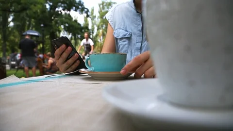 Close up Low Angle View of Young Woman Hands Using Phone in Cafe Stock Footage 109605449