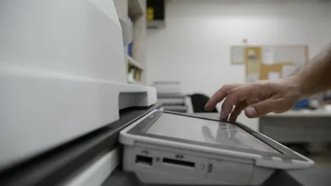 Close up low light. Someone work on modern copy machine at office. Stock Footage 132567141