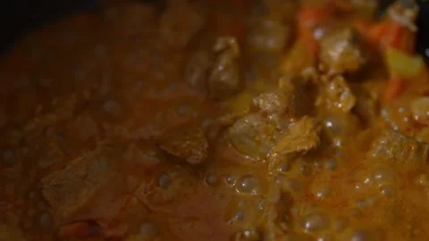 A close-up, low-light view of a rich orange-brown Stock Footage 328845314