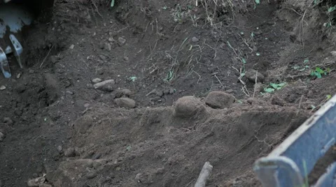 Close low pow digging dirt front of bucket Stock Footage 65712218