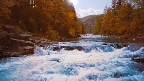 Close Up A low rapid flight over the rushing mountain river, blue in the middle Video stock 92131528