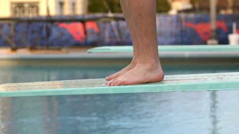 Close up low section view of legs of Caucasian man diving into swimming pool Video stock 191365887