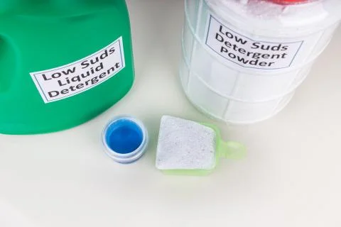 Close-up on low suds  laundry detergent for front load washing machine agains Stock Photos