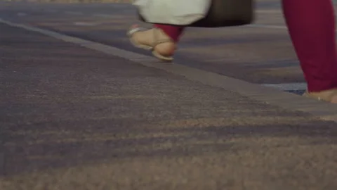 Close-up, Lower Angle, View of the Sidewalk on which Walkers Walk to Work on the Stock Footage 159316348