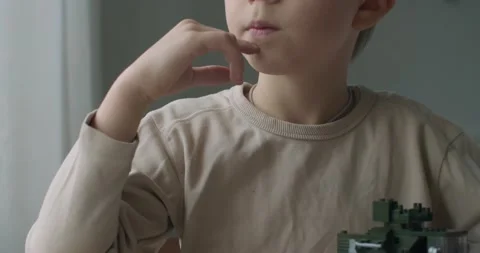 Close up lower half face portrait of kid boy sitting by window natural light Stock Footage 146445156