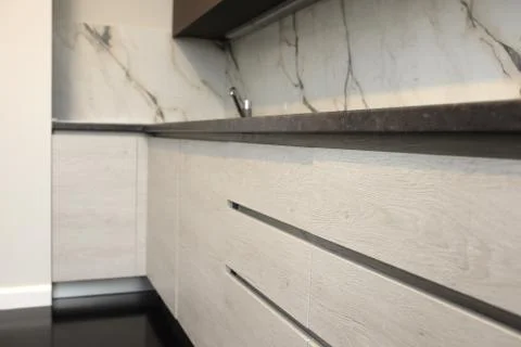 Close up of a lower part of a modern kitchen made of wood Stock Photos