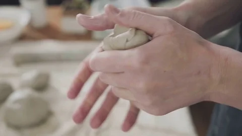 Close-up: a lump of white clay in the hands of a woman ceramist Video stock 73181338