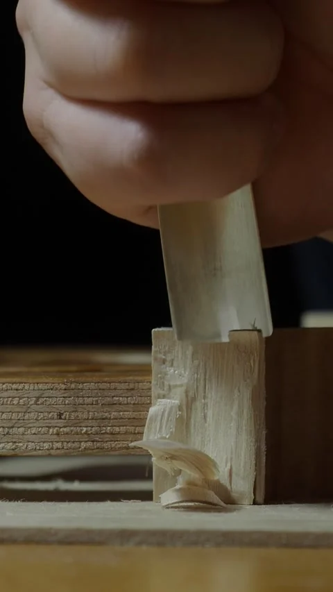 Close up of luthier's hands using bone scraper to smooth and shape wood corner Stock Footage 311694939