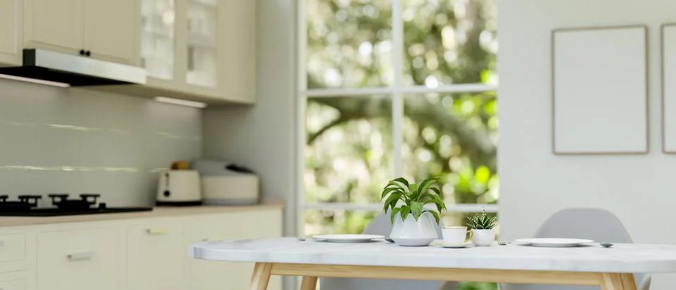 A close-up of a luxury white dining table in a modern white kitchen. Stock Photos