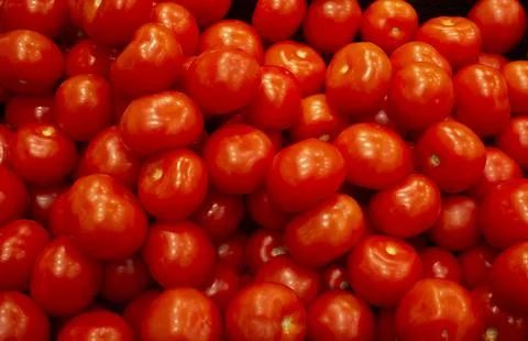 Close-up of lying fresh red tomatoes in supermarket boxes. Stock Photos