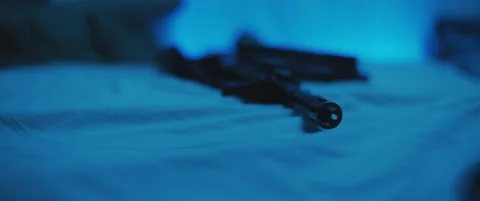 Close up of M16 rifle lying on a bed. Military, PTSD soldier concept. Cinemat Stock Footage 147537944
