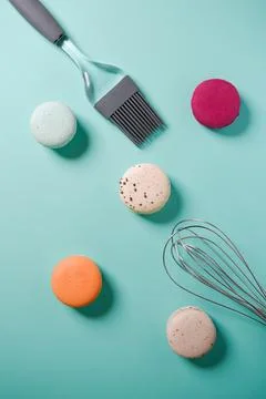 Close-up of macaroons of different colors in blue background. Culinary and .. Stock Photos