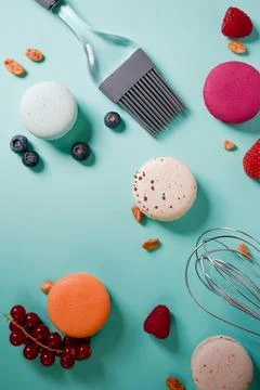 Close-up of macaroons of different colors in blue background. Culinary and .. Stock Photos