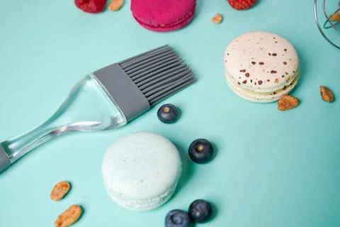 Close-up of macaroons of different colors in blue background. Culinary and .. Stock Photos