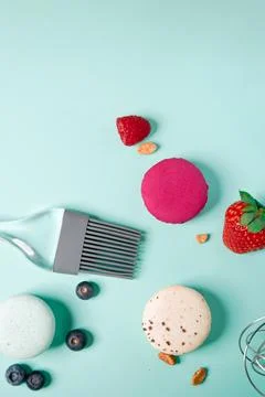 Close-up of macaroons of different colors in blue background. Culinary and .. Stock Photos