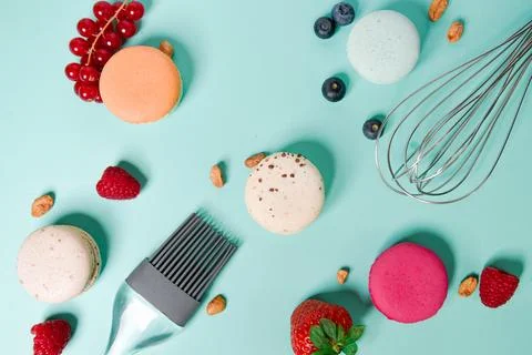 Close-up of macaroons of different colors in blue background. Culinary and .. Stock Photos