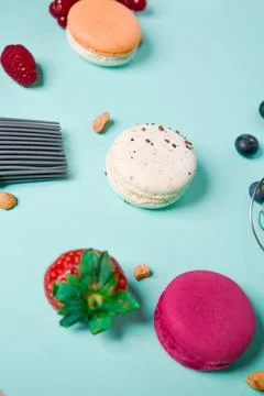 Close-up of macaroons of different colors in blue background. Culinary and .. Stock Photos