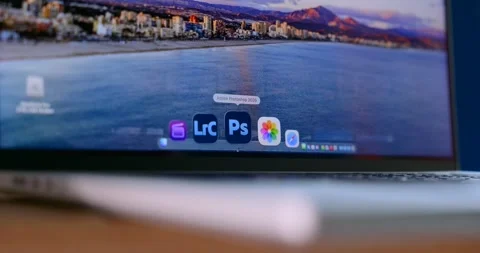Close up of a MacBook screen showing a media library Stock Footage 332616436
