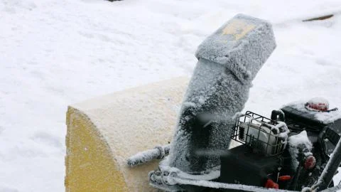 Close up machine cleans the road from snow. Stock Photos