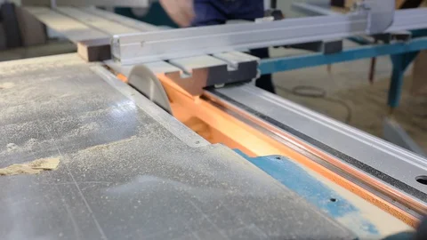 Close-up of machine with rotating circular saw, carpenter cuts wooden block Stock Footage 128391060