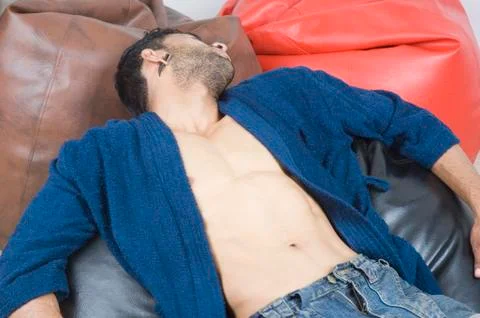 Close-up of a macho man lying on bean bags Fotos Stock