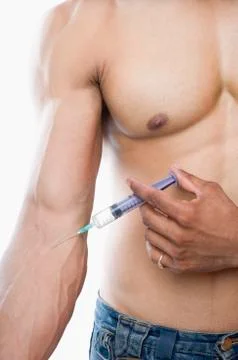 Close-up of a macho man taking steroids Stock Photos