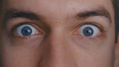 Close-up macro beautiful male's blue eyes portray fright and surprise Stock-Footage 120366229