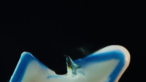 Close up macro of blowing out candle with number 3 on black background in slow Stock Footage 247129081