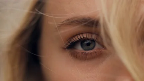 Close-up macro of the blue eye of a blond-haired woman Stock Footage 236558806