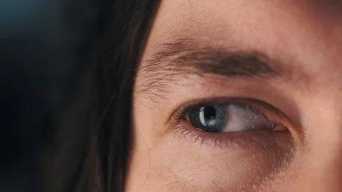 Close up macro blue eye watching different sides, beautiful iris natural human Stock Footage 130104550