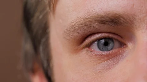 Close up macro of blue man eyes in macro looking at computer screen 스톡 동영상 124231132