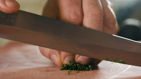 Close up macro chef man chopping cut green onion with knife on cutting board Stock Footage 107047465
