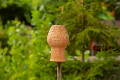 Close up, macro. Clay pots hanging to dry on a rustic wooden fence. On the Stock Photos