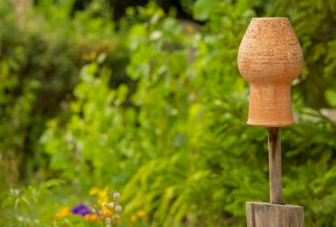 Close up, macro. Clay pots hanging to dry on a rustic wooden fence. On the Stock Photos