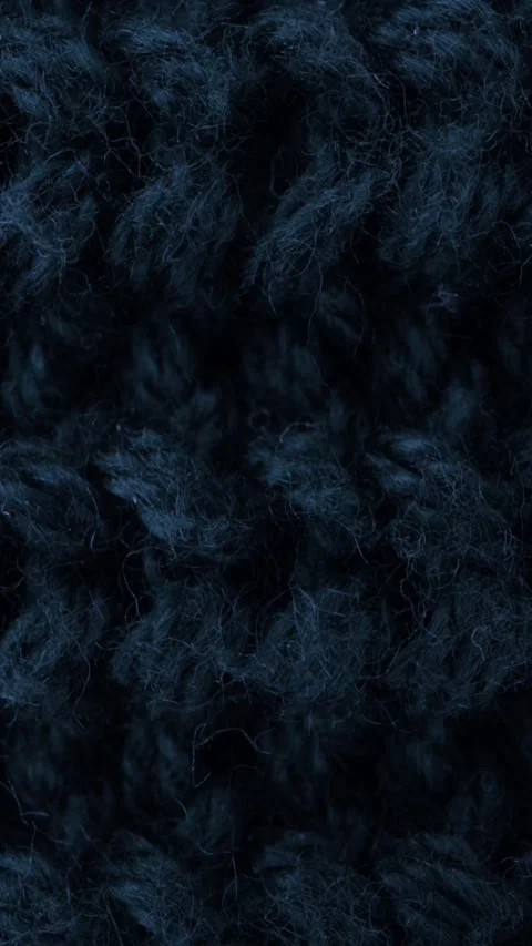 Close-up macro of dark navy knitted wool fabric showing soft fluffy texture Stock Footage 340670413